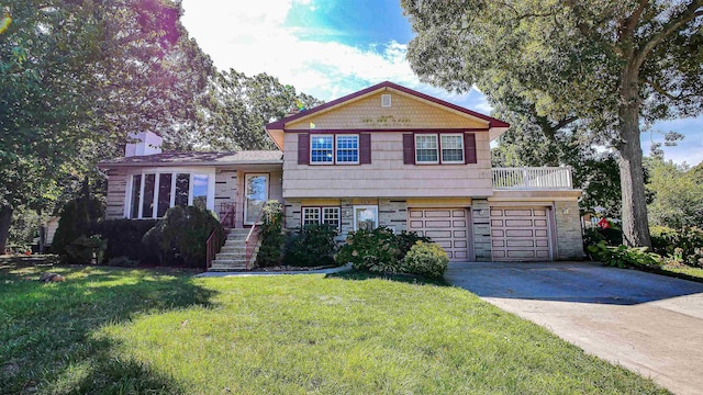 view of front of property featuring a garage and a front lawn