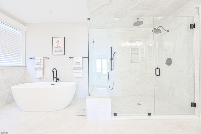 bathroom with tile walls and plus walk in shower