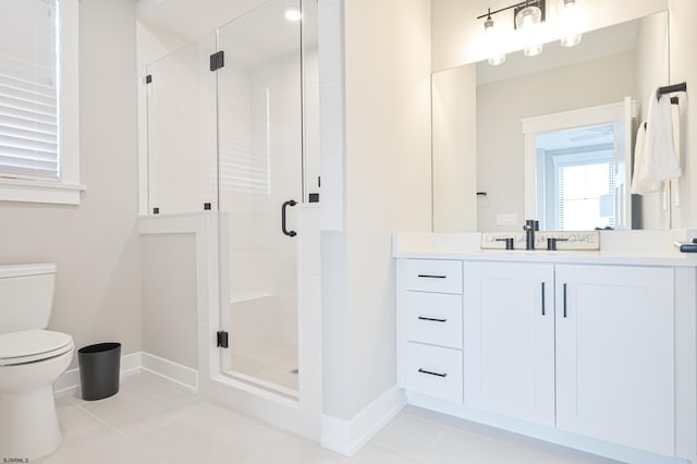 bathroom featuring vanity, toilet, a shower with shower door, and tile patterned floors