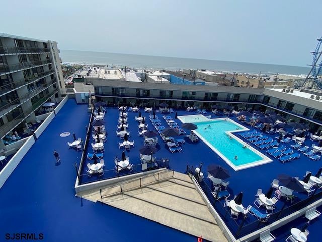 view of pool featuring a water view