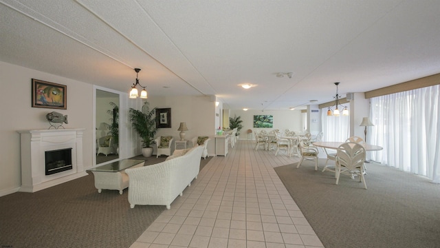 living room with a notable chandelier, a textured ceiling, and light colored carpet