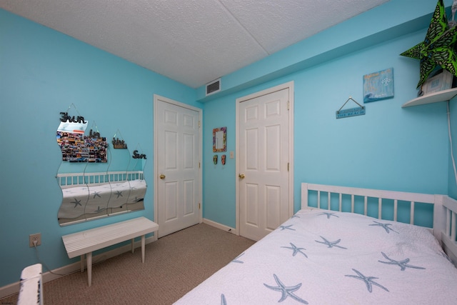 carpeted bedroom with a textured ceiling and a closet