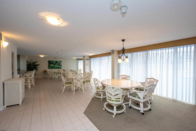 dining area with a textured ceiling and a chandelier