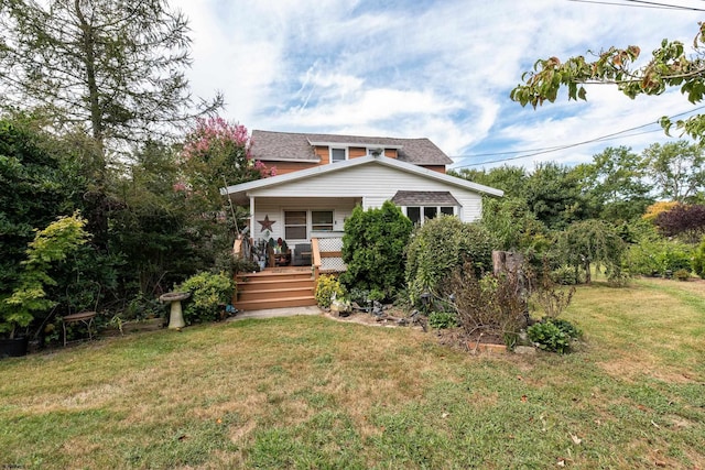 rear view of property featuring a yard