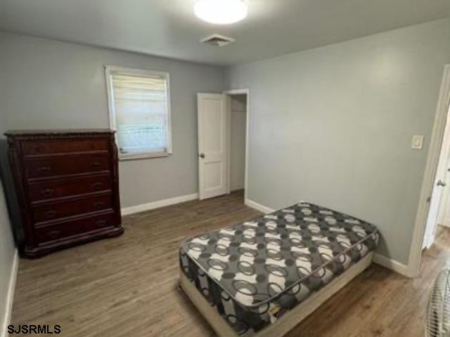 bedroom with hardwood / wood-style flooring