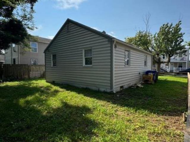 view of property exterior with a lawn