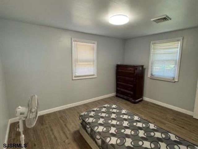 unfurnished bedroom with dark wood-type flooring