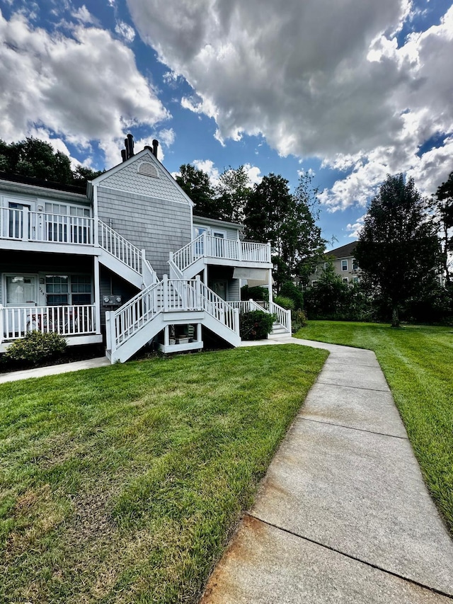 view of home's exterior with a deck and a lawn