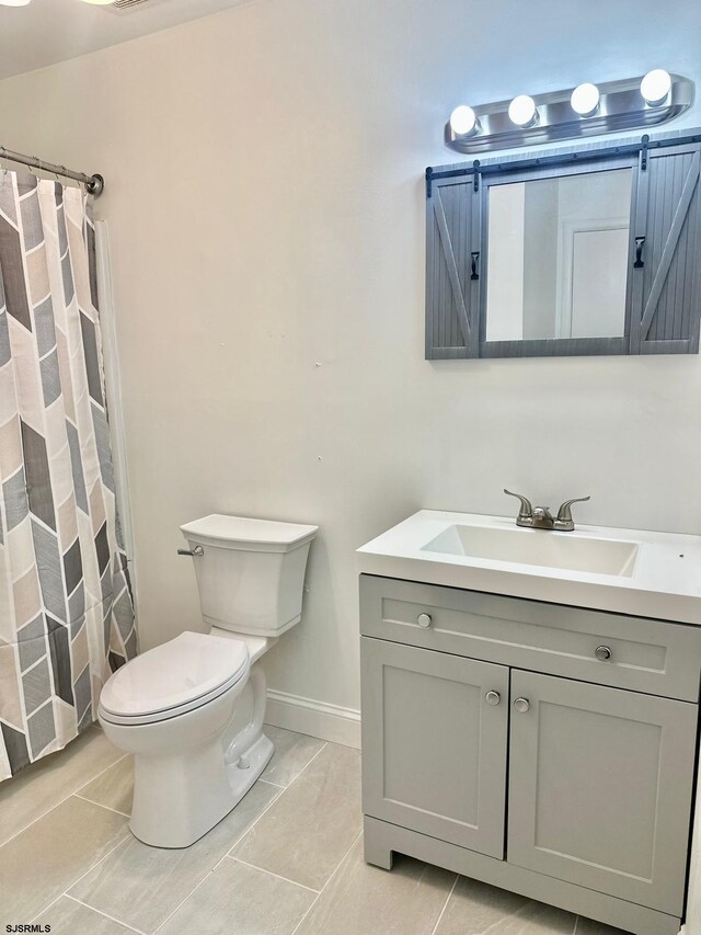 bathroom with a shower with curtain, tile patterned flooring, toilet, and vanity