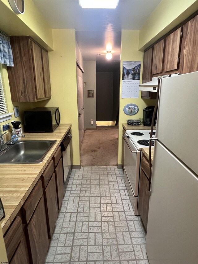 kitchen with white appliances and sink