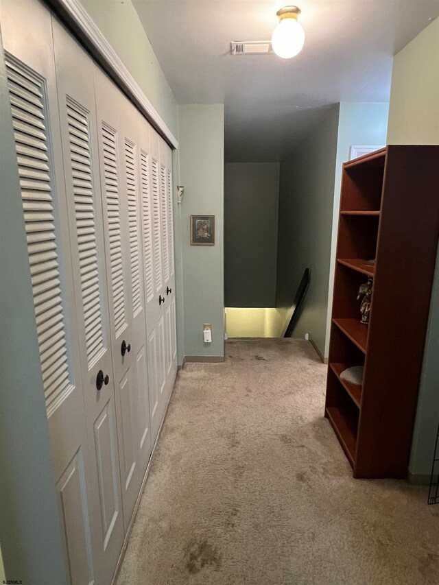 hallway featuring light carpet