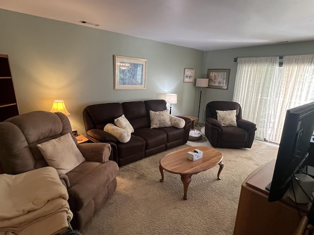 carpeted living room featuring visible vents