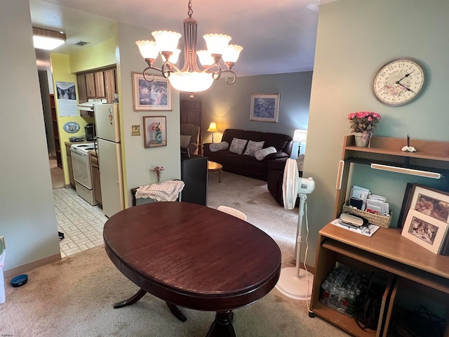 dining room with an inviting chandelier and light carpet