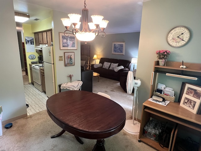 dining area featuring visible vents, light carpet, and an inviting chandelier