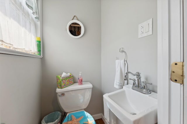 bathroom featuring toilet, hardwood / wood-style floors, and sink