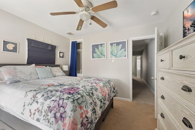 bedroom featuring a closet, ceiling fan, and light carpet