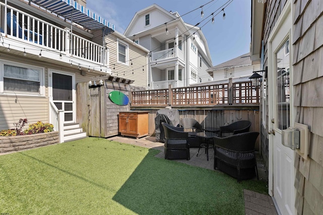 view of yard featuring a balcony and an outdoor living space