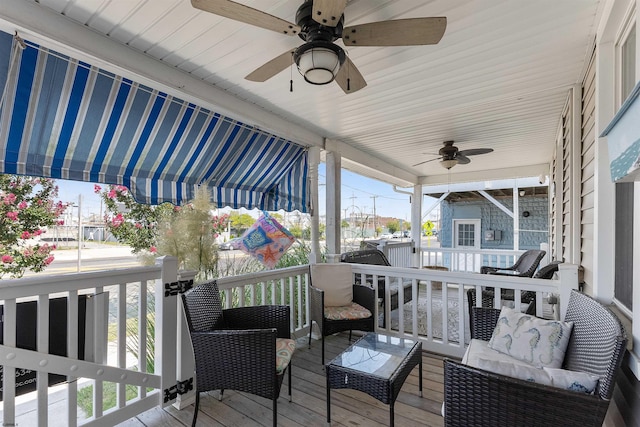 deck with outdoor lounge area and ceiling fan