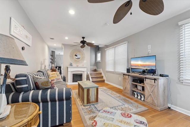 living room with hardwood / wood-style floors and ceiling fan