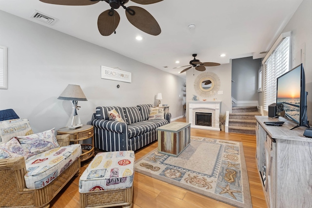 living room with ceiling fan and light hardwood / wood-style floors