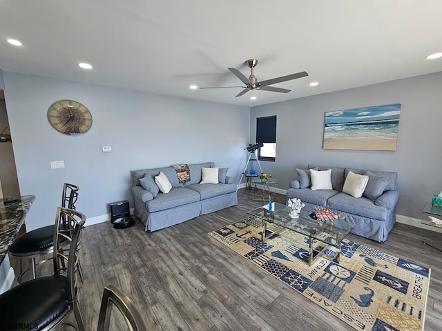 living room featuring dark hardwood / wood-style flooring and ceiling fan