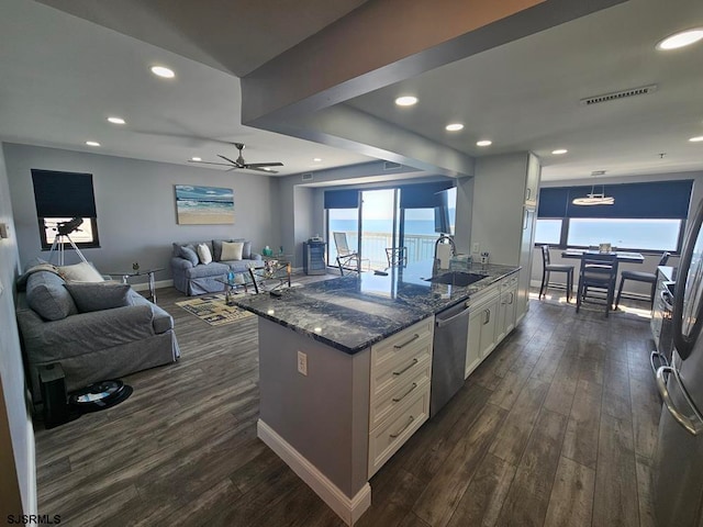 kitchen featuring white cabinets, stainless steel appliances, dark hardwood / wood-style flooring, sink, and ceiling fan