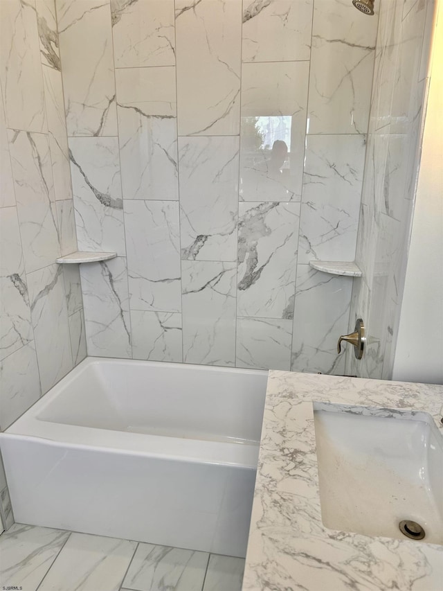 bathroom featuring a sink, shower / bath combination, and marble finish floor