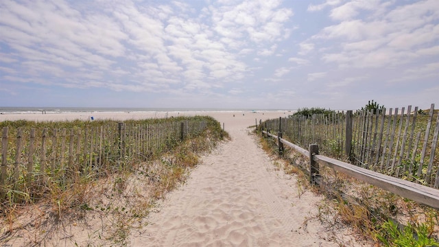 view of street with a water view and a beach view