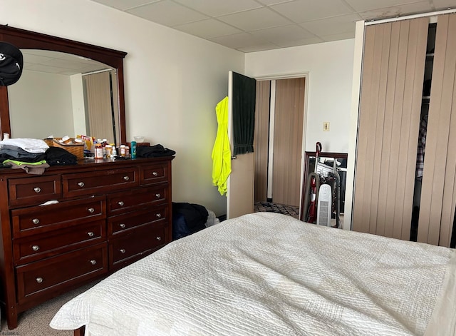 carpeted bedroom featuring a paneled ceiling