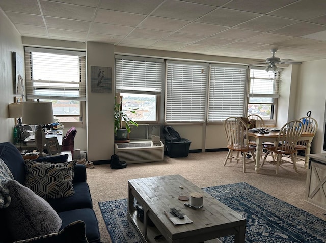 carpeted living room with a healthy amount of sunlight, ceiling fan, and a drop ceiling