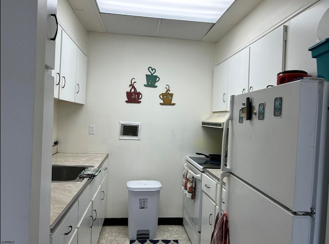 kitchen featuring a drop ceiling, white cabinets, white appliances, light tile patterned floors, and extractor fan