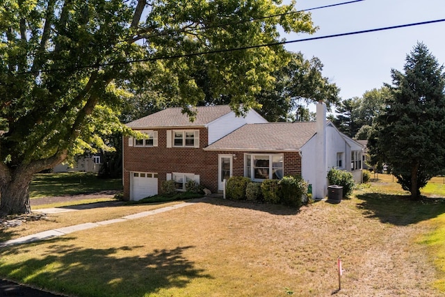 split level home with a garage and a front yard