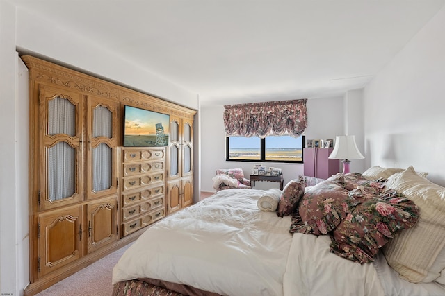 bedroom featuring light carpet