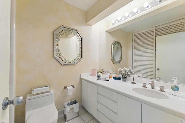 bathroom with tile patterned flooring, vanity, and toilet