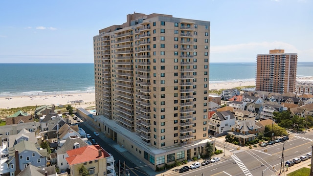 view of building exterior with a view of the beach and a water view