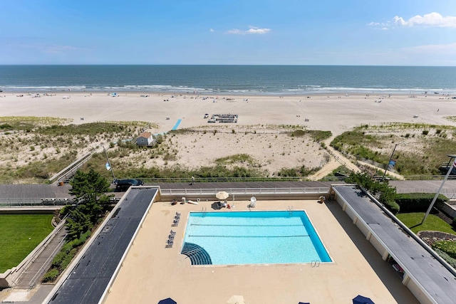 exterior space featuring a beach view and a water view