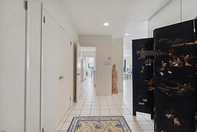 hall with light tile patterned floors