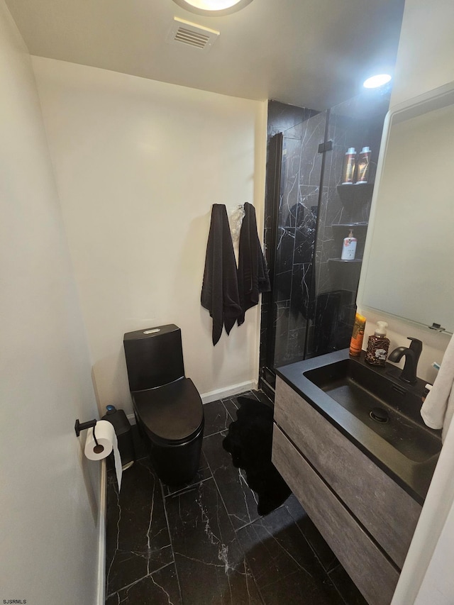 bathroom featuring tiled shower, toilet, and vanity