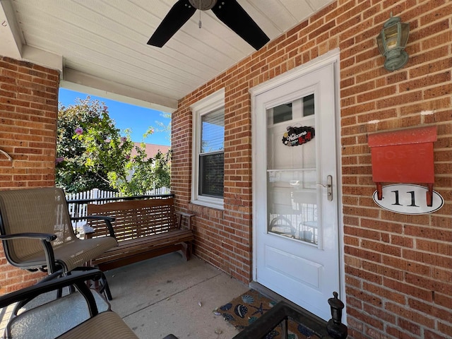 doorway to property with a porch and ceiling fan