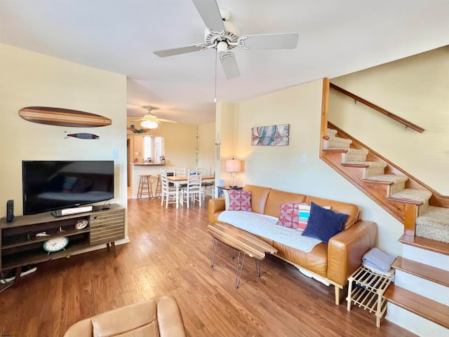 living room featuring ceiling fan and hardwood / wood-style flooring