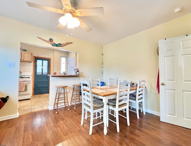 dining space featuring ceiling fan and light hardwood / wood-style floors