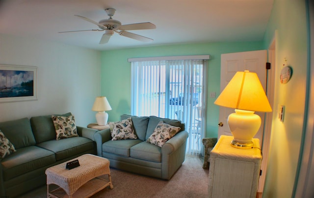 carpeted living room with ceiling fan