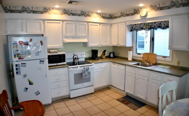 kitchen with sink, light tile patterned floors, white appliances, and white cabinetry