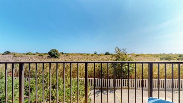 balcony featuring a rural view