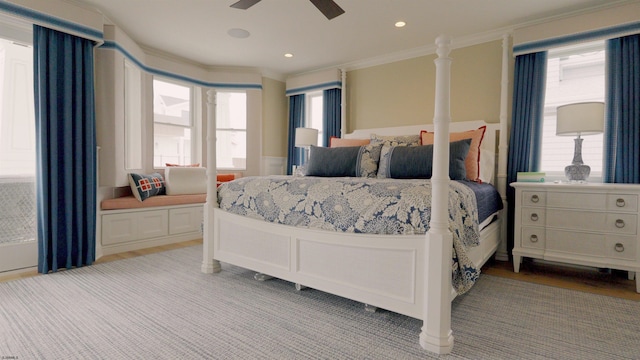 bedroom with crown molding, ceiling fan, and light hardwood / wood-style floors