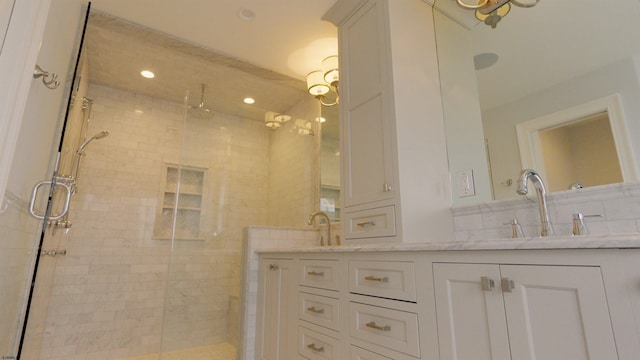 bathroom featuring an enclosed shower and vanity