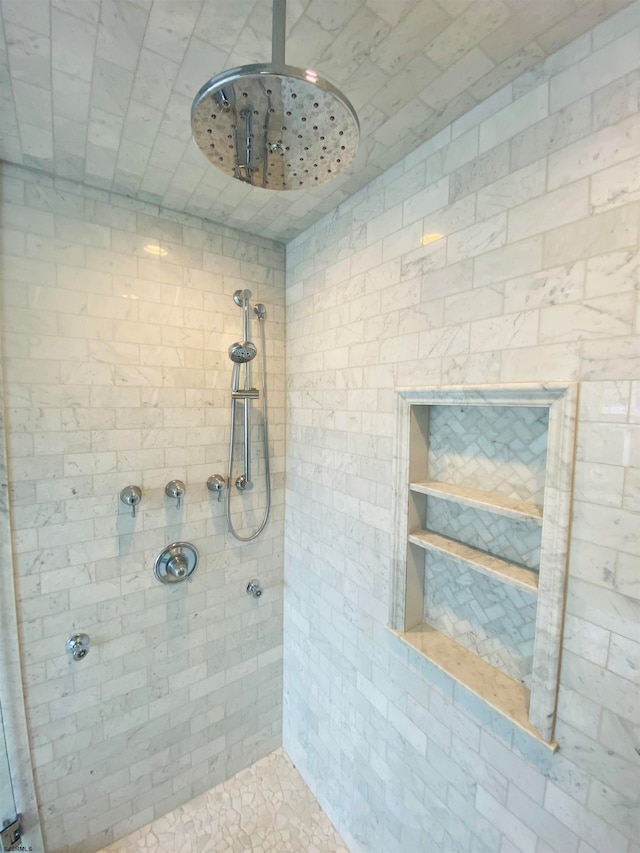 bathroom with a tile shower