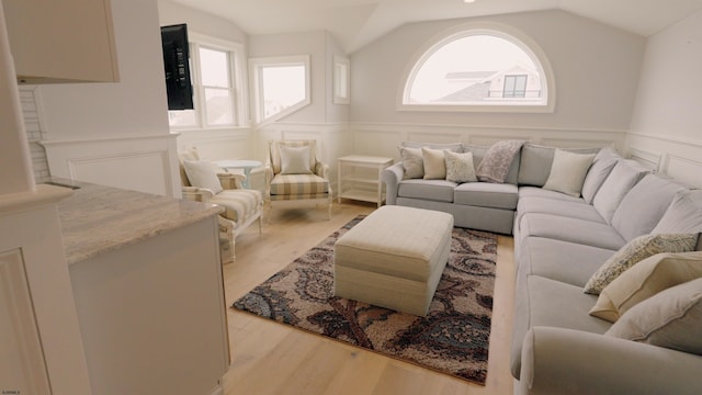 living room with lofted ceiling and light hardwood / wood-style floors