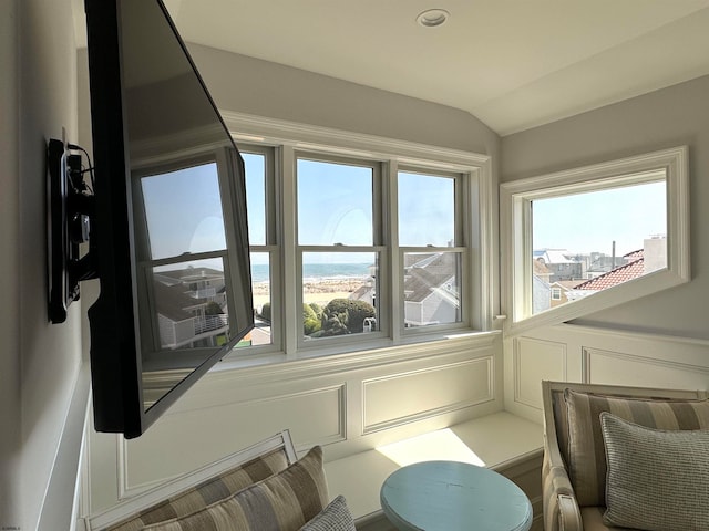 interior space featuring lofted ceiling and a water view