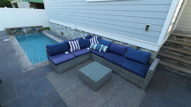 view of patio featuring an outdoor living space, pool water feature, and a fenced in pool